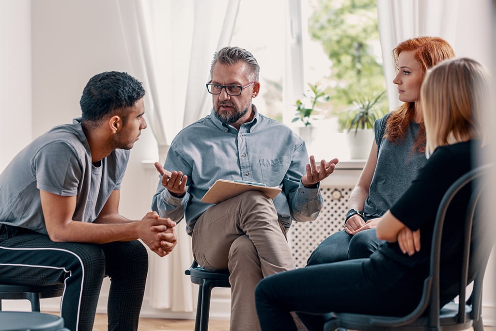 two expert relationship coaches discuss strategies with a married couple