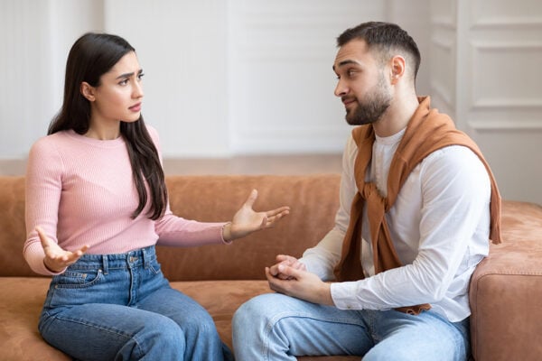 A couples communication workshop opens up conversation for a young couple on a couch